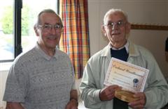 Wally Green presented with his certificate by Dennis Hill
